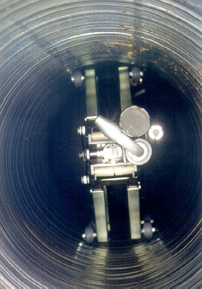 The STEER dry ice nozzle steering assembly operating inside a round duct